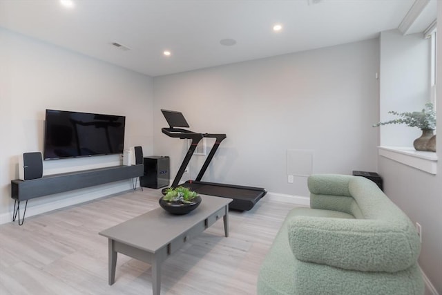 exercise room featuring light hardwood / wood-style floors