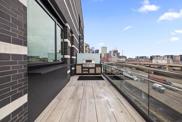 balcony featuring area for grilling and a city view