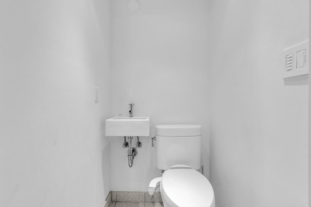 bathroom featuring toilet and tile patterned floors