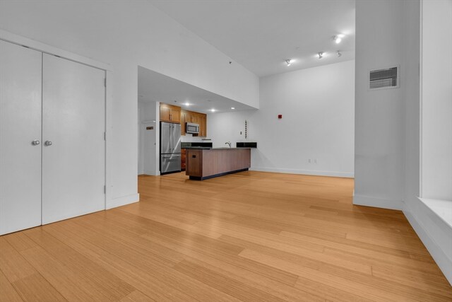 unfurnished living room featuring light hardwood / wood-style floors