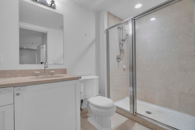 bathroom featuring vanity, toilet, tile patterned floors, and walk in shower