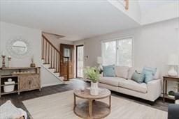 living room featuring wood finished floors and stairs