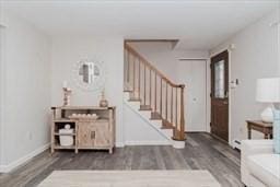 foyer entrance with baseboards, stairway, and wood finished floors