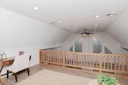 additional living space with vaulted ceiling, wood finished floors, and recessed lighting