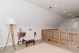 bonus room featuring vaulted ceiling, wood finished floors, and recessed lighting