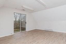 spare room with lofted ceiling and wood finished floors