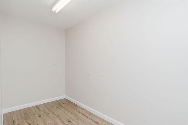 unfurnished room featuring light wood-style flooring and baseboards