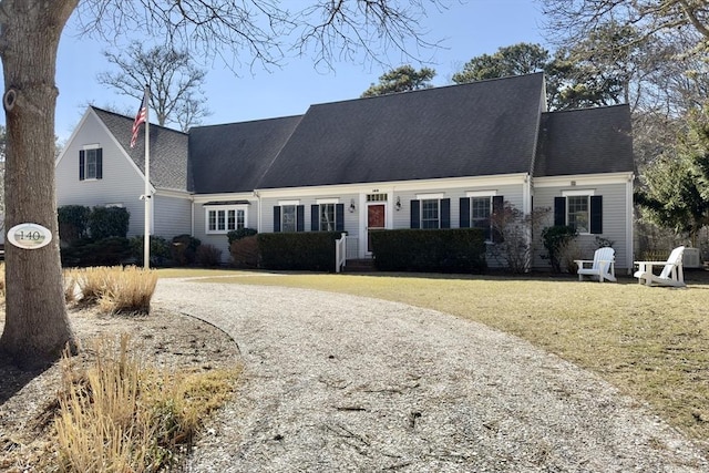 cape cod home with a front lawn