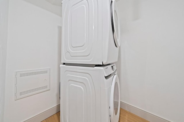 59 Falcon St Unit 1, Boston, MA 02128 - laundry area featuring estacked washer and dryer and light wood-style floors
