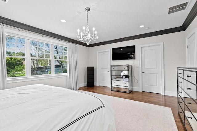 bedroom featuring baseboards, dark wood finished floors, a chandelier, and visible vents
