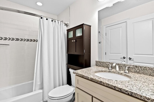 bathroom with vanity, toilet, and shower / bath combo with shower curtain