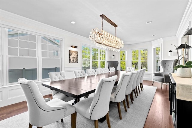 dining space featuring recessed lighting, ornamental molding, wood finished floors, and a notable chandelier