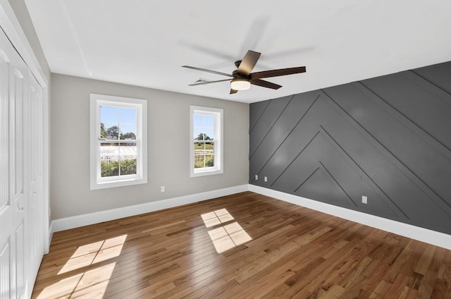 interior space featuring wood-type flooring and ceiling fan