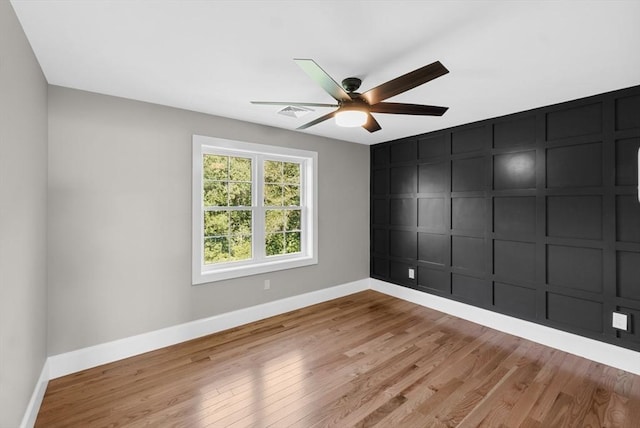 empty room with ceiling fan and light wood-type flooring