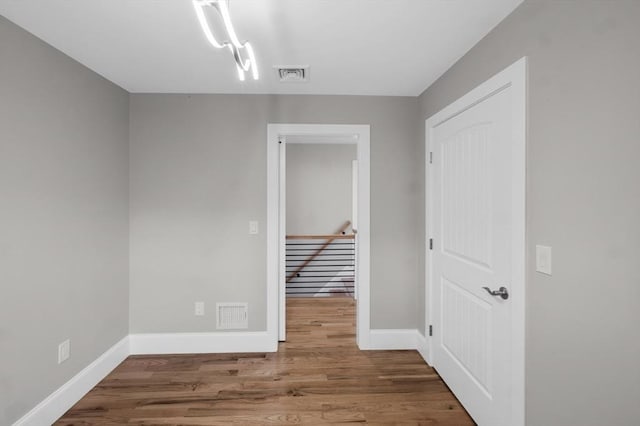 spare room with wood-type flooring