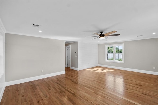 empty room featuring crown molding, ceiling fan, and light wood-type flooring