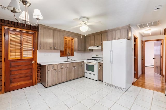 kitchen featuring decorative light fixtures, sink, white appliances, ceiling fan with notable chandelier, and a baseboard radiator