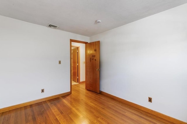 unfurnished room with light hardwood / wood-style floors