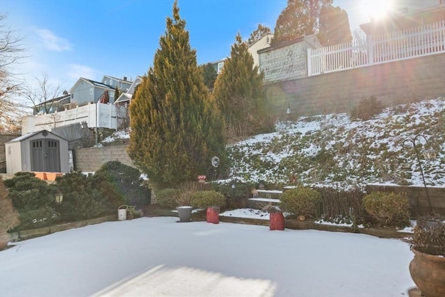 snowy yard with a shed