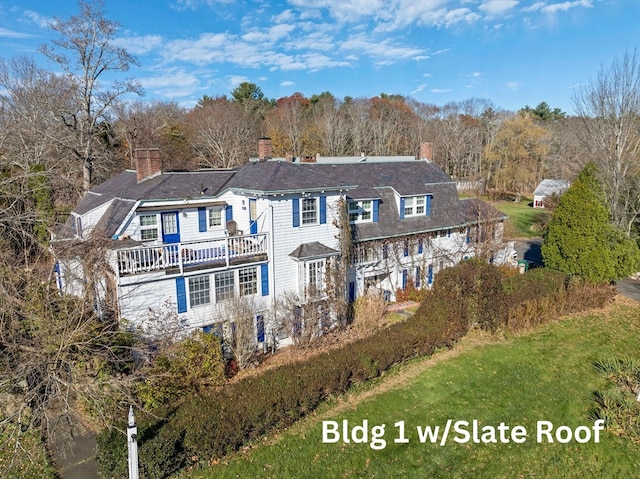 back of property with a balcony