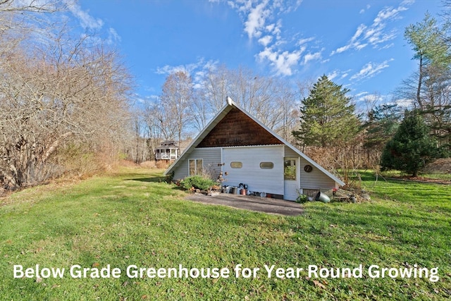 rear view of property with a lawn