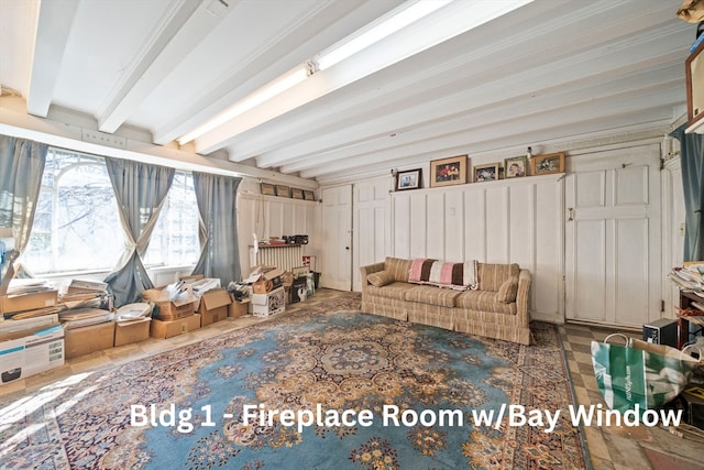 unfurnished living room featuring beam ceiling