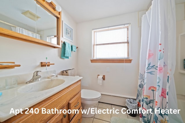 bathroom with toilet, vanity, and tile patterned floors