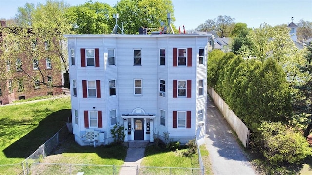 855 Liberty St, Springfield, MA 01104 - italianate home featuring a front yard, a fenced front yard, and driveway