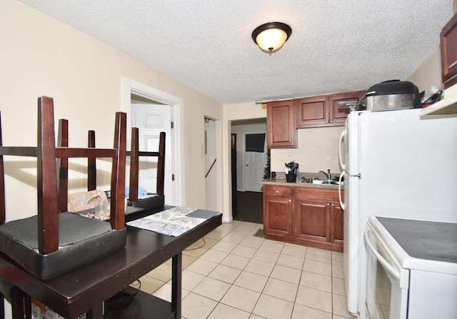 855 Liberty St, Springfield, MA 01104 - kitchen featuring light tile patterned floors, light countertops, white electric stove, and a textured ceiling