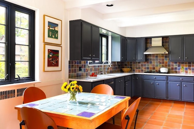 5 Southwick, Newton, MA 02468 - kitchen with wall chimney exhaust hood, decorative backsplash, light tile patterned floors, a sink, and beam ceiling