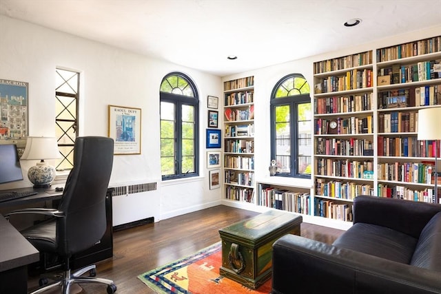 5 Southwick, Newton, MA 02468 - office area with radiator heating unit, built in shelves, wood finished floors, wall of books, and baseboards