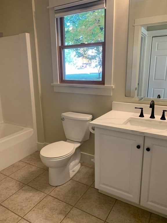 bathroom featuring vanity, toilet, and tile patterned flooring