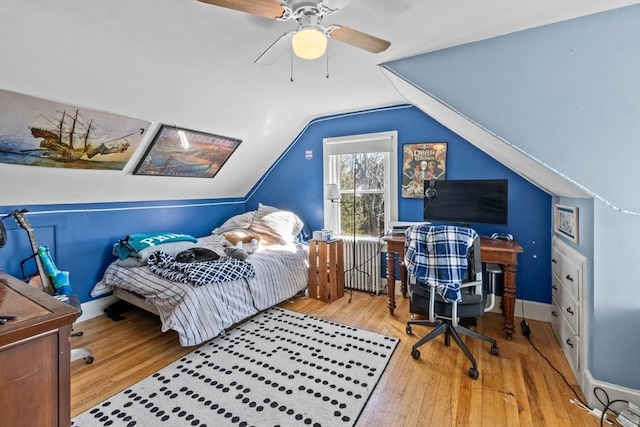 bedroom featuring lofted ceiling, wood finished floors, a ceiling fan, and baseboards