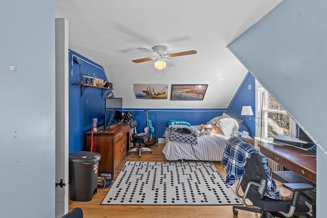 bedroom featuring ceiling fan, vaulted ceiling, and wood finished floors