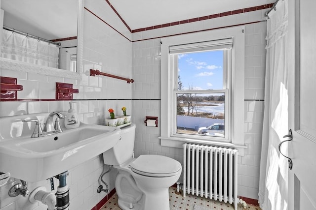 bathroom featuring a shower with curtain, toilet, tile walls, and radiator heating unit