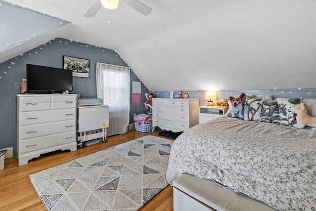 bedroom with lofted ceiling, ceiling fan, and wood finished floors