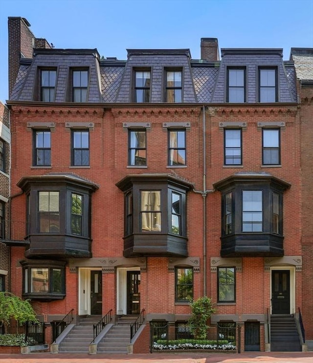 multi unit property with mansard roof and brick siding