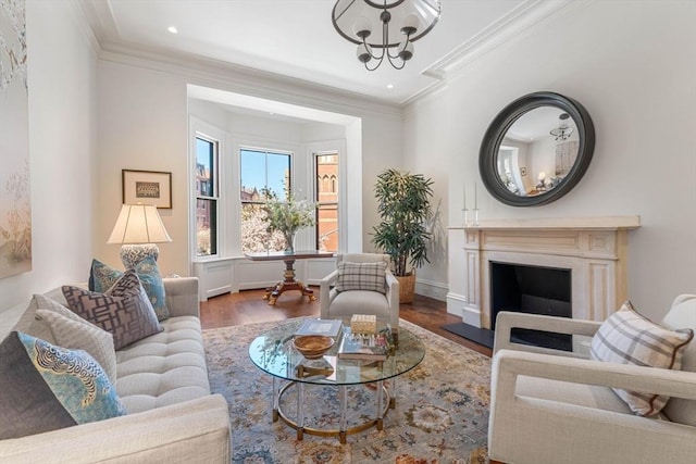 living area with a fireplace with flush hearth, a notable chandelier, wood finished floors, recessed lighting, and crown molding