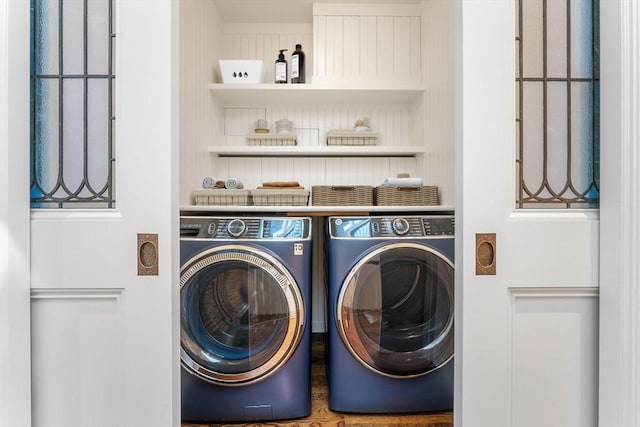 clothes washing area featuring laundry area and separate washer and dryer