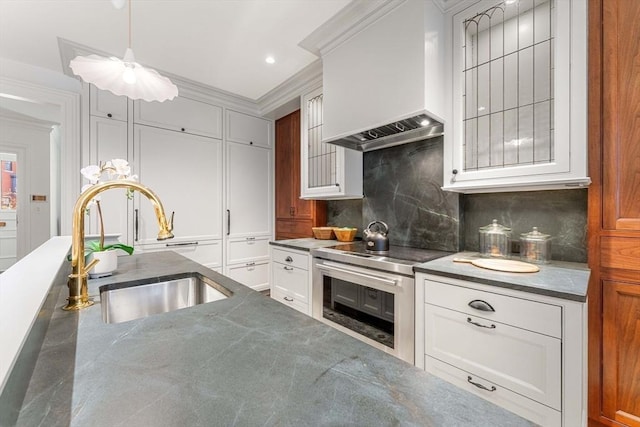 kitchen with backsplash, crown molding, stainless steel range with electric stovetop, custom exhaust hood, and a sink