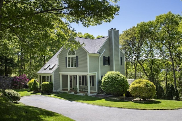 2181 Service Rd, Barnstable, MA 02668 - view of front of property featuring a chimney, a front yard, and a shingled roof