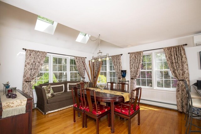 2181 Service Rd, Barnstable, MA 02668 - dining space featuring a baseboard radiator, a skylight, light wood-style floors, vaulted ceiling, and healthy amount of natural light