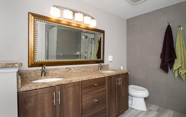 2181 Service Rd, Barnstable, MA 02668 - bathroom with a shower stall, toilet, and double vanity