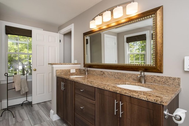 2181 Service Rd, Barnstable, MA 02668 - full bathroom featuring double vanity, a baseboard heating unit, and plenty of natural light