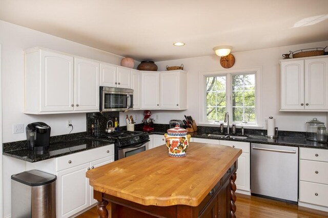 2181 Service Rd, Barnstable, MA 02668 - kitchen featuring stainless steel appliances, a sink, white cabinets, dark stone counters, and recessed lighting