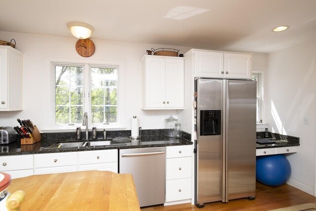 2181 Service Rd, Barnstable, MA 02668 - kitchen featuring stainless steel appliances, a sink, dark stone counters, white cabinets, and light wood-type flooring