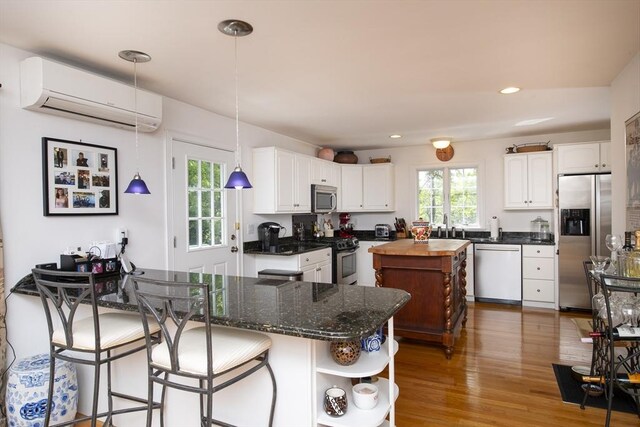 2181 Service Rd, Barnstable, MA 02668 - kitchen with stainless steel appliances, a wall mounted AC, open shelves, healthy amount of natural light, and recessed lighting