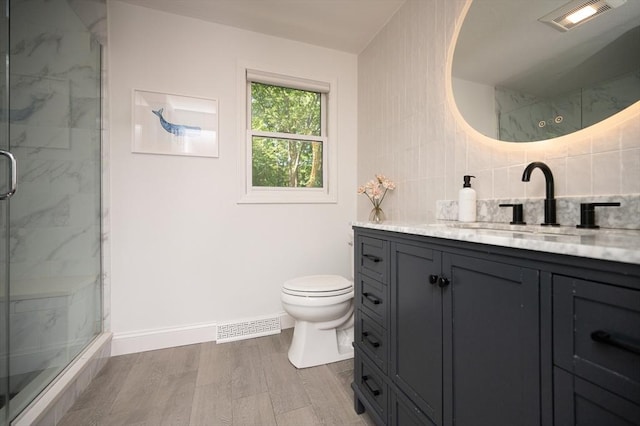 3 Eileen Rd, Norton, MA 02766 - full bath with vanity, toilet, a marble finish shower, wood finished floors, and decorative backsplash