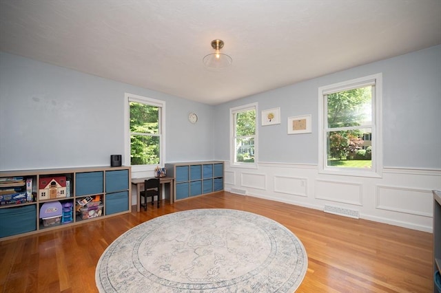 3 Eileen Rd, Norton, MA 02766 - rec room featuring plenty of natural light, a wainscoted wall, and wood finished floors