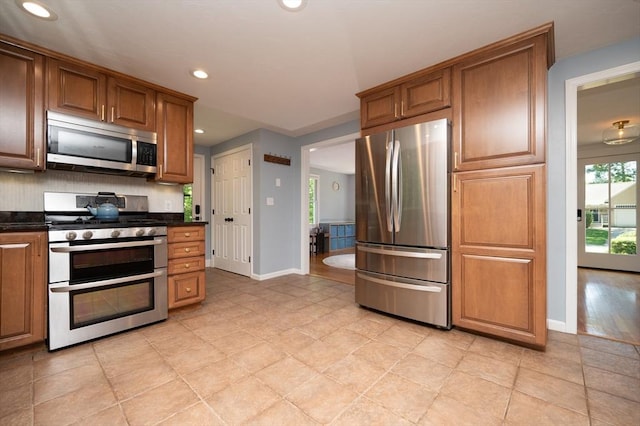 3 Eileen Rd, Norton, MA 02766 - kitchen featuring appliances with stainless steel finishes, dark countertops, baseboards, recessed lighting, and brown cabinets